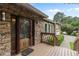 Close up of stone facade and a wood framed glass front door at 3711 Frey Lake Nw Rd, Kennesaw, GA 30144
