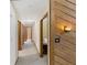 Hallway featuring light-colored walls and carpet, accented with warm wood trim and paneling at 3711 Frey Lake Nw Rd, Kennesaw, GA 30144