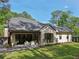 Well-maintained backyard includes lush lawn, manicured landscaping, and an outdoor patio at 477 Michael Dr, Alpharetta, GA 30009