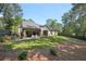 Large backyard featuring a covered patio with outdoor seating, lush green lawn, and privacy fence and mature trees at 477 Michael Dr, Alpharetta, GA 30009