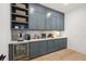 Chic bar area featuring custom cabinets, beverage cooler, and stylish decor at 477 Michael Dr, Alpharetta, GA 30009