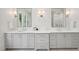 Bright bathroom featuring dual sinks with gray cabinets, quartz countertops, and modern lighting at 477 Michael Dr, Alpharetta, GA 30009