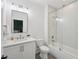 Bright bathroom with white cabinets, tile floor, and a shower/tub combo with glass door at 477 Michael Dr, Alpharetta, GA 30009