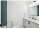 Well-lit bathroom featuring modern vanity with black hardware and sleek, rectangular mirror at 477 Michael Dr, Alpharetta, GA 30009