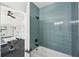 Partial view of a bathroom with a unique teal tiled shower and view into the gym at 477 Michael Dr, Alpharetta, GA 30009