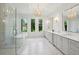 A luxurious bathroom with marble floors, a glass-enclosed shower, and a soaking tub by the windows at 477 Michael Dr, Alpharetta, GA 30009