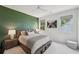 Cozy bedroom features a unique olive colored wall, a ceiling fan, and natural light at 477 Michael Dr, Alpharetta, GA 30009