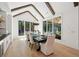 Bright dining room with wood beams, large windows, and modern chandelier lighting at 477 Michael Dr, Alpharetta, GA 30009