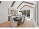 Elegant dining room with beamed ceilings, large picture window, a dark wooden table and built in cabinets at 477 Michael Dr, Alpharetta, GA 30009