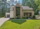 Stunning brick home with modern windows, well-manicured lawn and an attached two car garage at 477 Michael Dr, Alpharetta, GA 30009