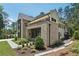 Elegant brick home featuring meticulous landscaping and a covered entryway with dark trim at 477 Michael Dr, Alpharetta, GA 30009