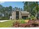 Beautifully designed home with a blend of brick and siding, complemented by lush green landscaping at 477 Michael Dr, Alpharetta, GA 30009
