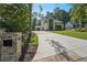 Stunning home exterior features a long driveway, lush landscaping, and manicured front lawn at 477 Michael Dr, Alpharetta, GA 30009