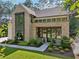 An eye-level shot of a beautifully designed brick home with modern window and door trim and beautiful landscaping at 477 Michael Dr, Alpharetta, GA 30009