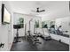 Home gym with rubber flooring, large mirror, ceiling fan, and plenty of workout equipment at 477 Michael Dr, Alpharetta, GA 30009