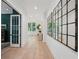 Well-lit hallway with hardwood floors and decorative mirror panels on the wall at 477 Michael Dr, Alpharetta, GA 30009
