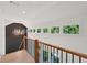 Bright hallway featuring a wooden railing, series of windows, and paneled wall with decorative chandelier at 477 Michael Dr, Alpharetta, GA 30009