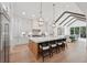 Bright, open kitchen with hardwood floors, large island with seating, and a view into dining area at 477 Michael Dr, Alpharetta, GA 30009