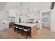 Spacious kitchen with a large center island, pendant lighting, white cabinets and stainless steel appliances at 477 Michael Dr, Alpharetta, GA 30009