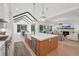 Open-concept kitchen with hardwood floors, island with seating, and views into the living area and dining nook at 477 Michael Dr, Alpharetta, GA 30009