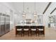 Open-concept kitchen featuring a large island with seating, stainless steel appliances and hardwood floors at 477 Michael Dr, Alpharetta, GA 30009
