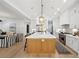 Bright kitchen with hardwood floors, a spacious island with seating, and open views of the living room at 477 Michael Dr, Alpharetta, GA 30009