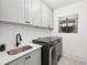 Well-equipped laundry room features modern appliances, stylish cabinetry, and tiled floors at 477 Michael Dr, Alpharetta, GA 30009