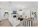 Living room featuring white sofas, modern light fixtures, and a brick fireplace at 477 Michael Dr, Alpharetta, GA 30009