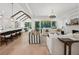 Open-concept living room with wood floors, fireplace, and access to the backyard at 477 Michael Dr, Alpharetta, GA 30009