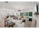 Bright living room featuring a fireplace and an open floor plan into the kitchen at 477 Michael Dr, Alpharetta, GA 30009
