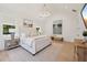 Spacious main bedroom featuring light wood floors, a decorative chandelier and expansive painting at 477 Michael Dr, Alpharetta, GA 30009