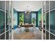 Stylish home office with rich blue walls, natural light, and modern decor at 477 Michael Dr, Alpharetta, GA 30009