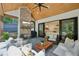 Covered patio featuring a brick fireplace, ceiling fan, slate flooring and comfortable seating at 477 Michael Dr, Alpharetta, GA 30009