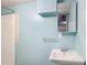 Small blue tiled bathroom featuring a white sink, mirror, shower, and good lighting at 60 Ivy Dr, Covington, GA 30016