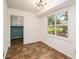 Bright dining room featuring modern light fixture, large window, and access to laundry area at 60 Ivy Dr, Covington, GA 30016