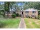 Charming brick home with a stone chimney and lush green lawn at 60 Ivy Dr, Covington, GA 30016