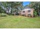Spacious front yard with mature trees surrounding a brick home at 60 Ivy Dr, Covington, GA 30016