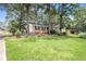 Well-maintained lawn and landscaping enhance this brick home at 60 Ivy Dr, Covington, GA 30016