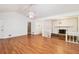 Open living room with hardwood floors and a stone fireplace at 60 Ivy Dr, Covington, GA 30016