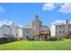 Spacious backyard with a well-manicured lawn and a raised deck perfect for outdoor entertaining at 915 Pebble Creek Trl, Suwanee, GA 30024