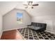 Bright bedroom with vaulted ceiling and window with wood floors and ceiling fan at 915 Pebble Creek Trl, Suwanee, GA 30024