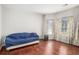 Bedroom with wood floors, many windows, and bright walls at 915 Pebble Creek Trl, Suwanee, GA 30024
