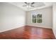 Bedroom featuring hard wood floors, neutral walls, tray ceilings and lots of natural light at 915 Pebble Creek Trl, Suwanee, GA 30024