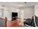 Bonus room with wood floors, black futon, TV, a window, and carpet rug at 915 Pebble Creek Trl, Suwanee, GA 30024