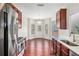 Bright breakfast nook with wood floors and stainless steel appliances with white countertops at 915 Pebble Creek Trl, Suwanee, GA 30024