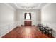 Elegant dining room featuring hardwood floors, wainscoting, and a chandelier with modern furnishings at 915 Pebble Creek Trl, Suwanee, GA 30024