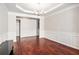 Spacious dining room with hardwood floors, detailed trim work, and a modern chandelier at 915 Pebble Creek Trl, Suwanee, GA 30024