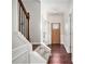 Welcoming entryway with hardwood floors, a staircase with iron railings, and a view of the front door at 915 Pebble Creek Trl, Suwanee, GA 30024