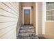 Inviting front entrance with stone steps leading to a wood door with sidelights and decorative sconces at 915 Pebble Creek Trl, Suwanee, GA 30024