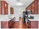 Well-equipped kitchen featuring dark cabinetry, light countertops, and stainless steel appliances at 915 Pebble Creek Trl, Suwanee, GA 30024